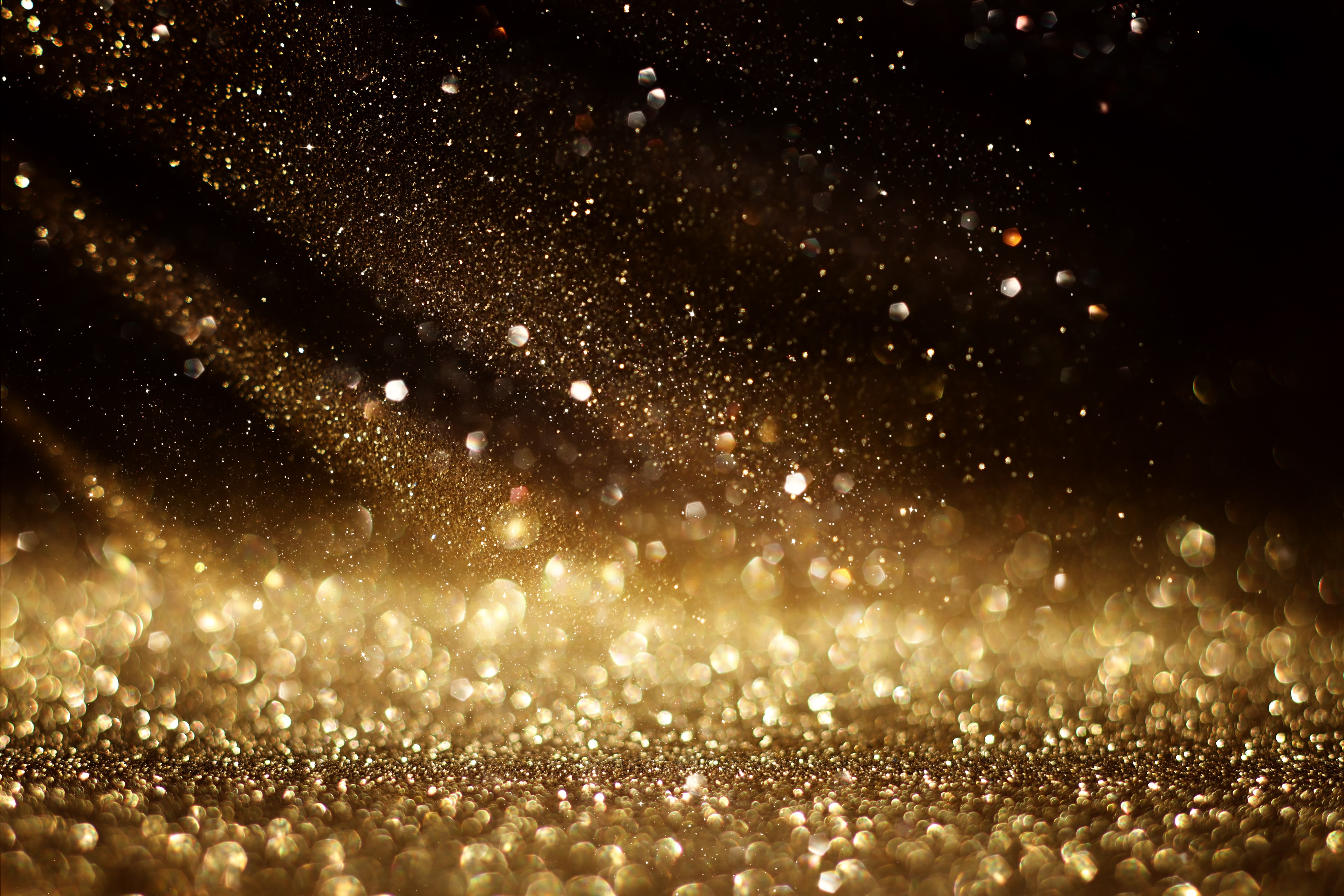 background of abstract gold and black glitter lights. defocused